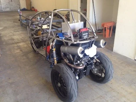 Step 2: Bare welded tubular steel CTx chassis with Aprilia RSV1000R powertrain and twin rear tires in the shop
