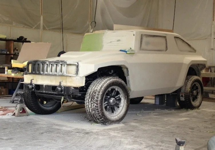 Full-scale Rhino XT clay model mounted on rolling chassis in the styling and fabrication shop