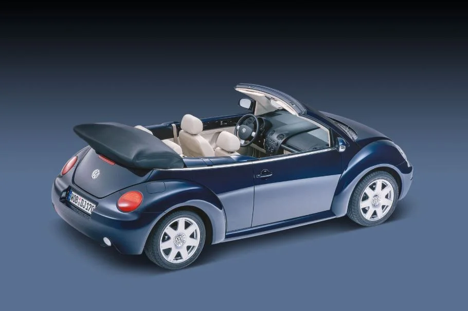 Volkswagen New Beetle Convertible driving with soft top open